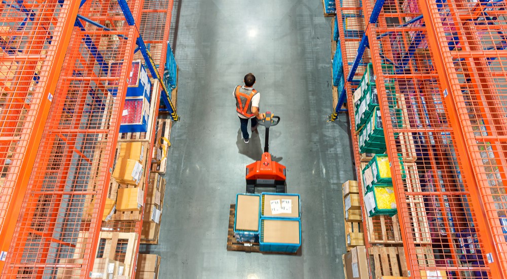 Man pulling a pallet in warehouse