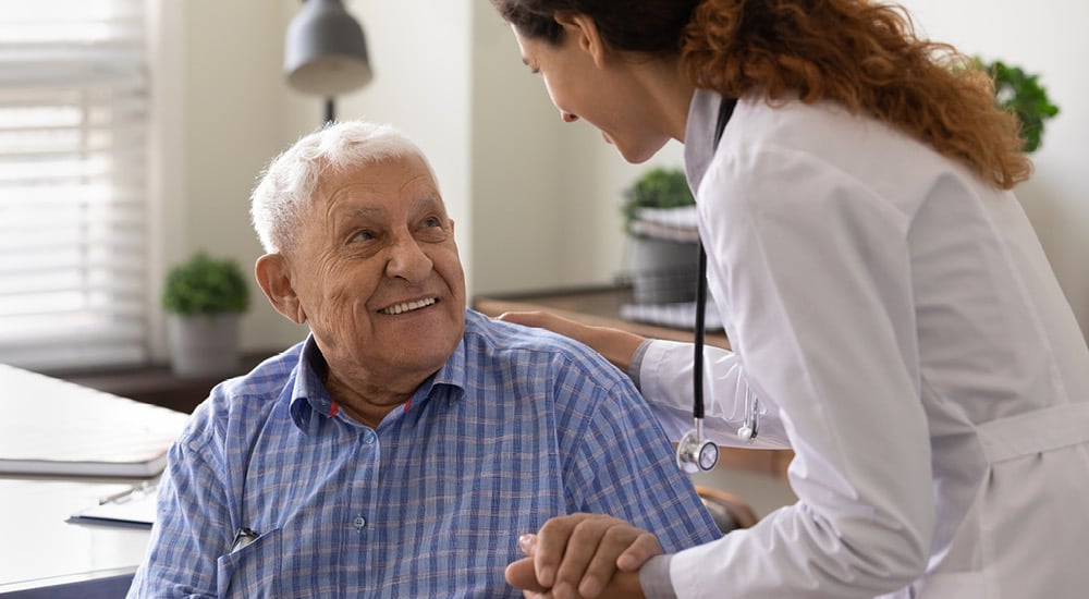 Healthcare professional speaking with an older patient about health, wellbeing and support options