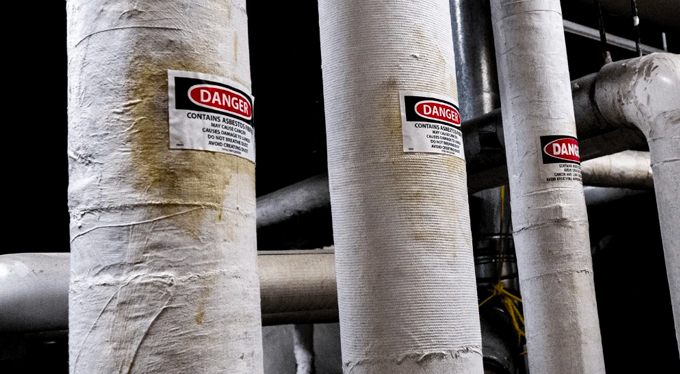 Encapsulated asbestos ducting with warning sign