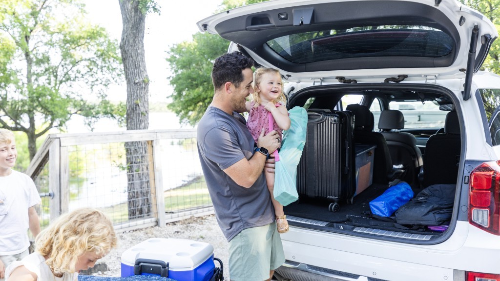 Dad and children unloading the back of the car