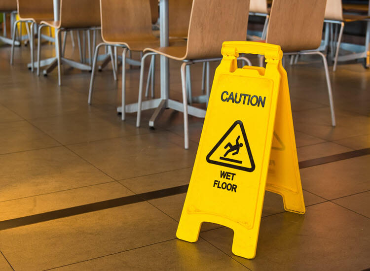 Yellow caution wet floor sign in restaurant