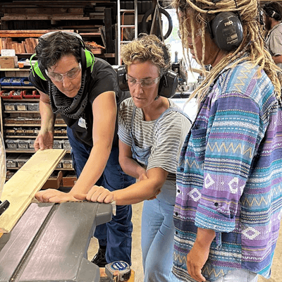 Attendees learning carpentry skills from the Shedding Community Workshop Inc.