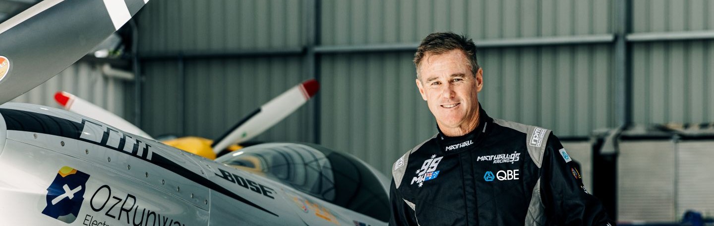 Aviator Matt Hall standing next to an aircraft