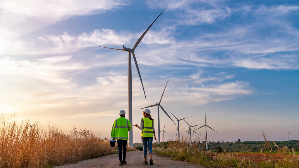 Engineers wearing hi-vis clothing working at a wind turbine farm