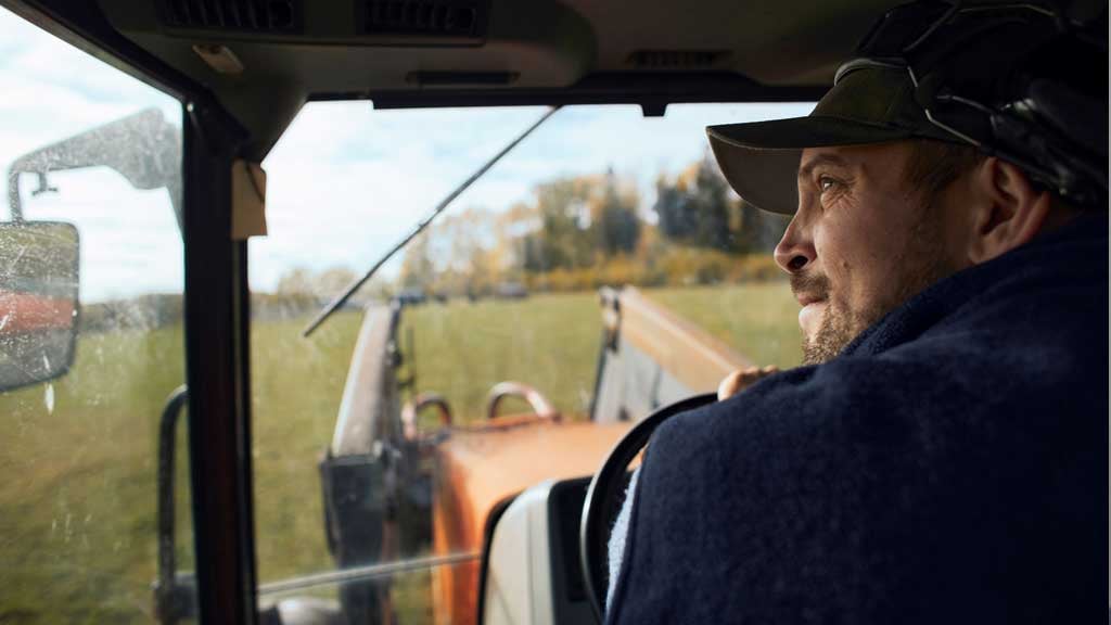 Rear view of a farmer in a tractor