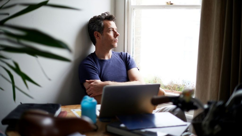 Man looking pensively out of window
