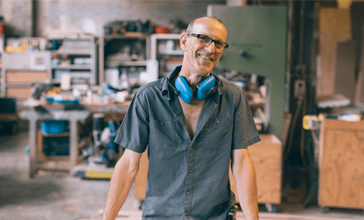 Claims innovation - man standing in his workshop