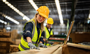 Young female carpenter at work