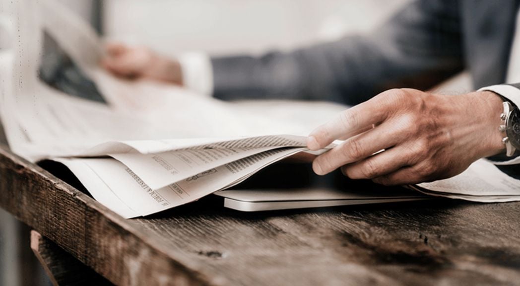 Close up of man reading newspaper