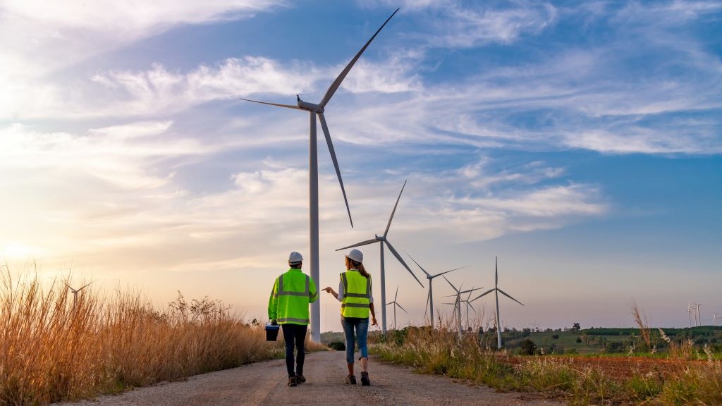 Engineers wearing uniforms during inspection work on wind turbine farm