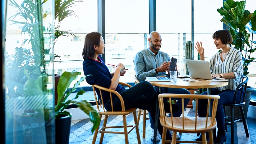 Three relaxed business colleagues meeting in cafe