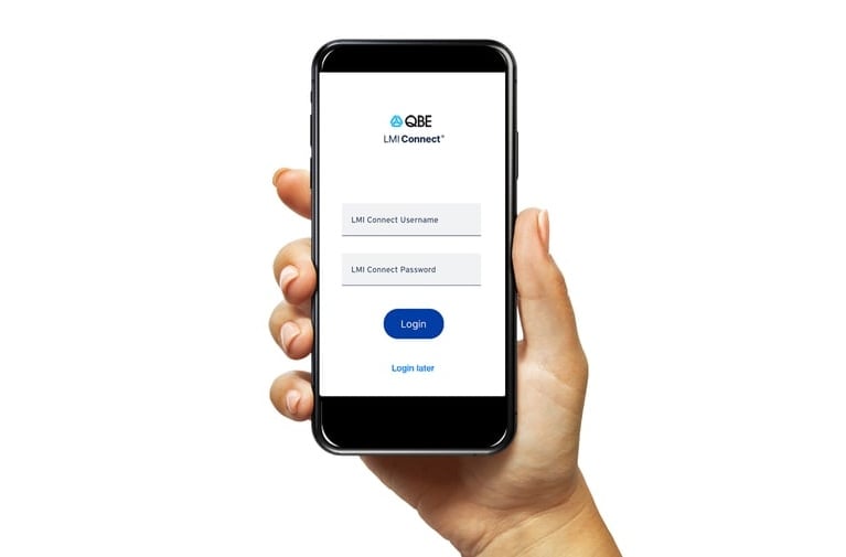 A hand holding up a smartphone displaying the LMI Connect login screen.