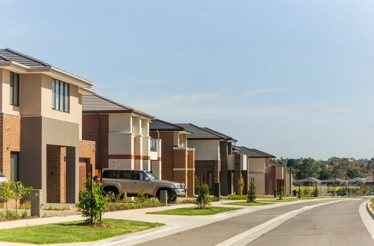 A row of newly built suburban homes along a residential street