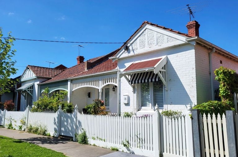 Detached residential home with a front fence, representing a property purchase that may require lenders mortgage insurance.