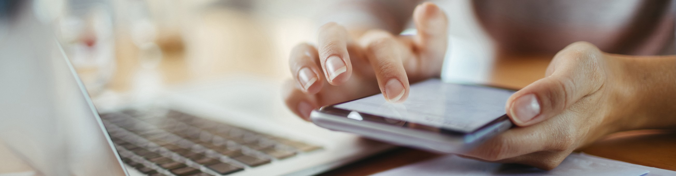 Close up of woman using a phone at her desk