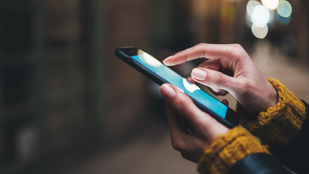 Close up of woman's hands using mobile phone