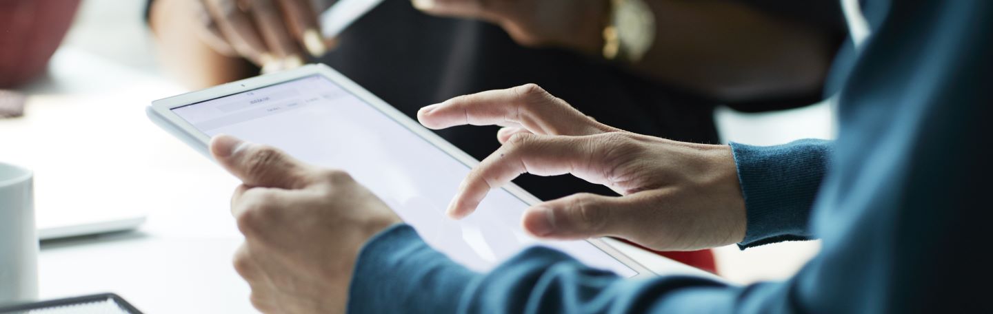 Close up of man using tablet device