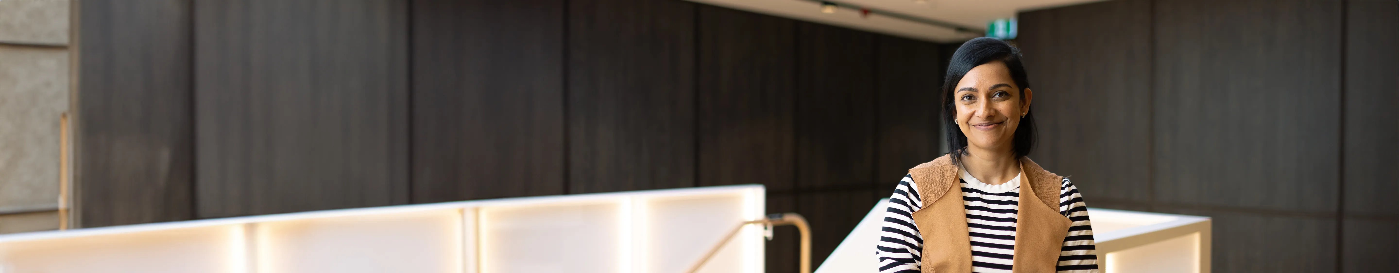 QBE graduate smiling in QBE Sydney office