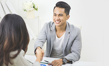 woman talking and smiling to another woman