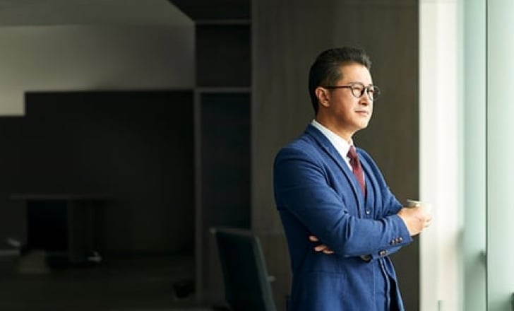 Professional standing in front of a window