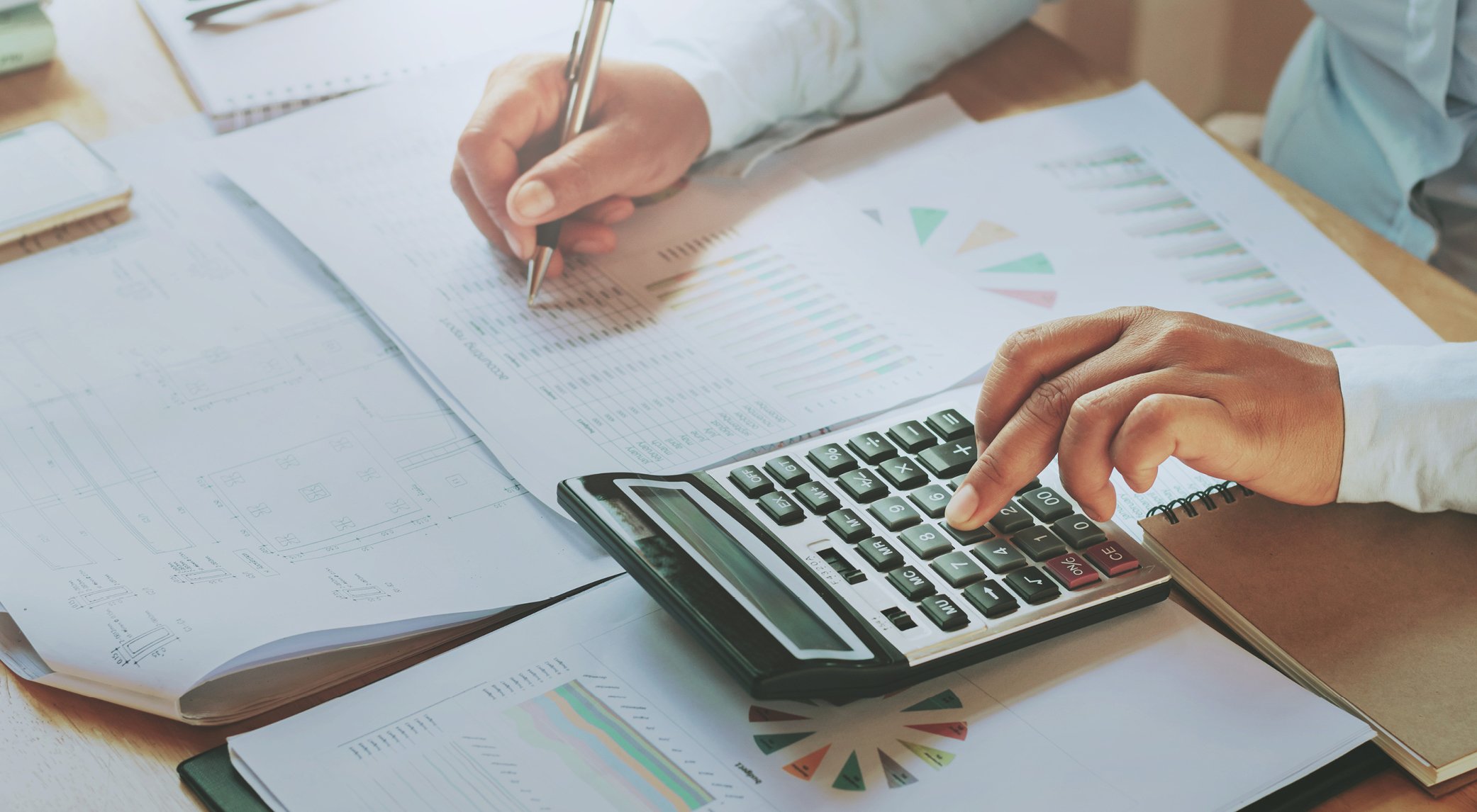 Person using calculator at desk