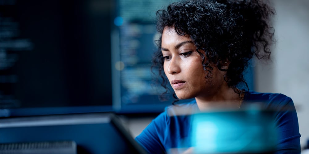LPS Cyber Whitepaper woman sitting at a computer