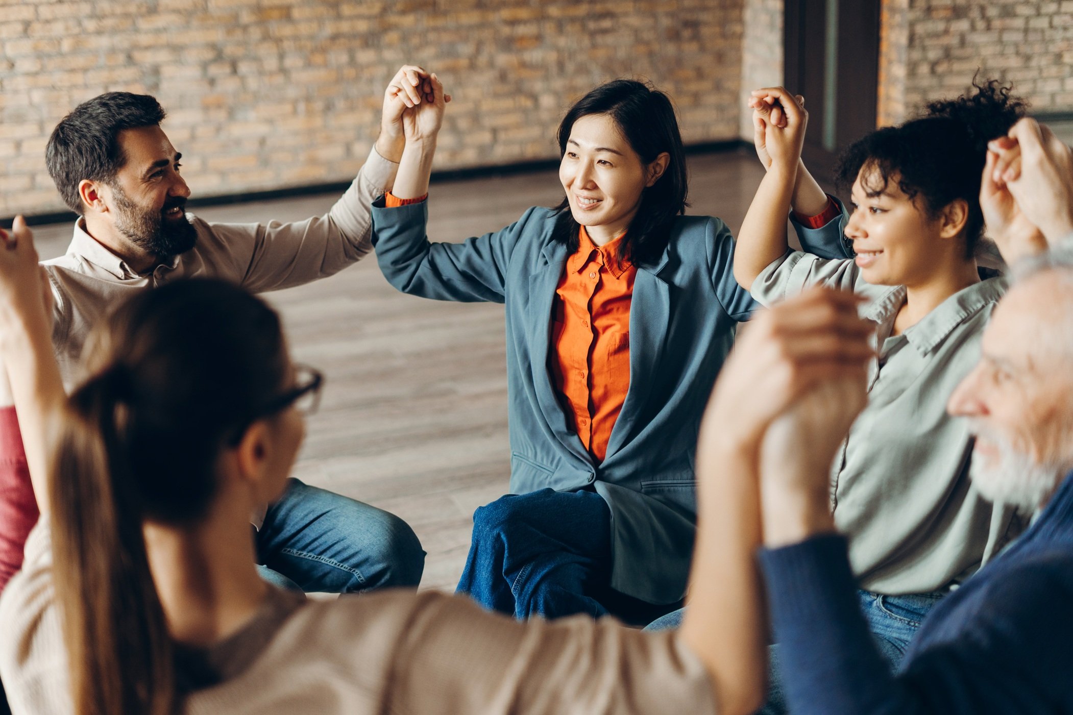 group of diverse people holiding hands